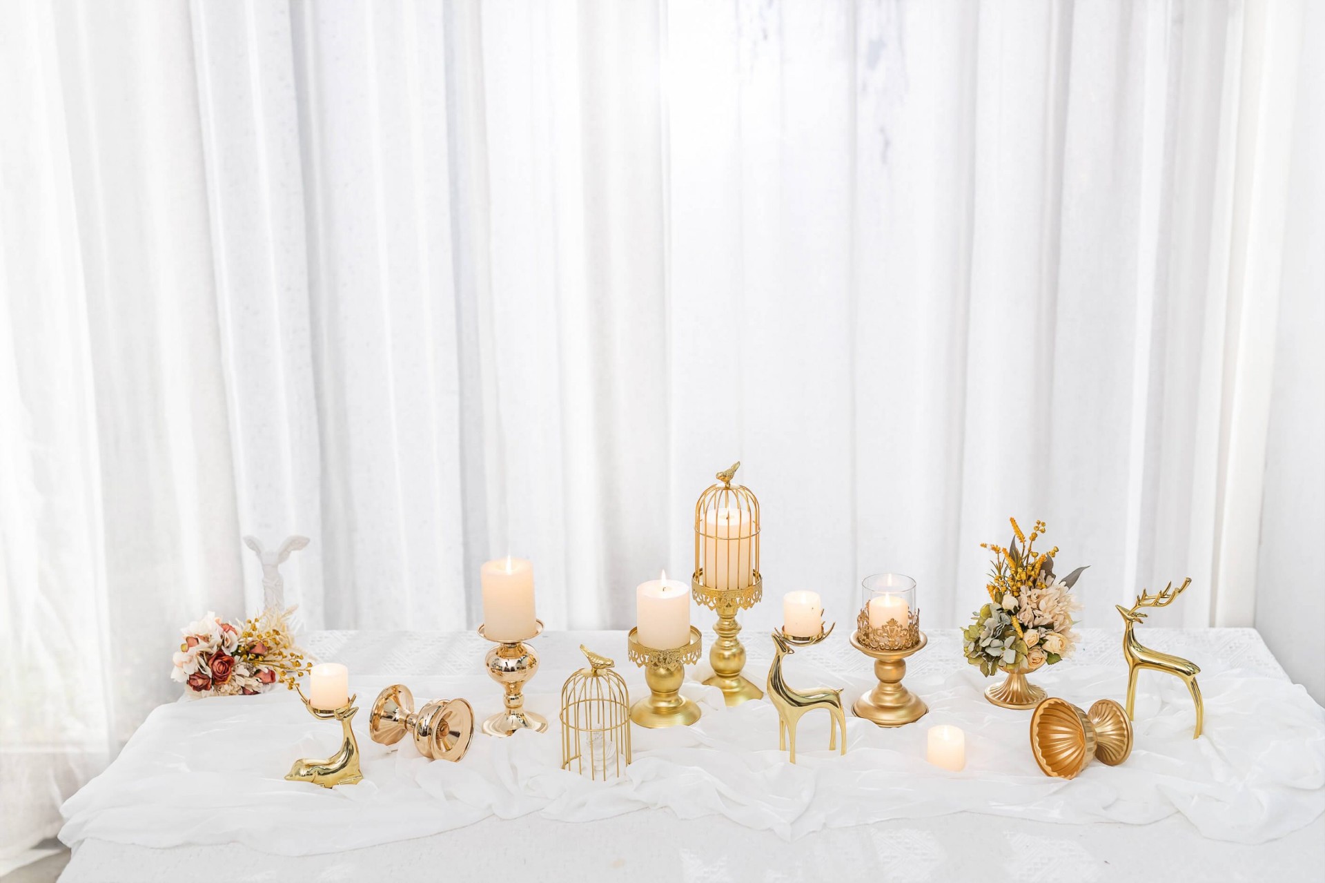 Wedding tablescape with gold candelabras and candle holders